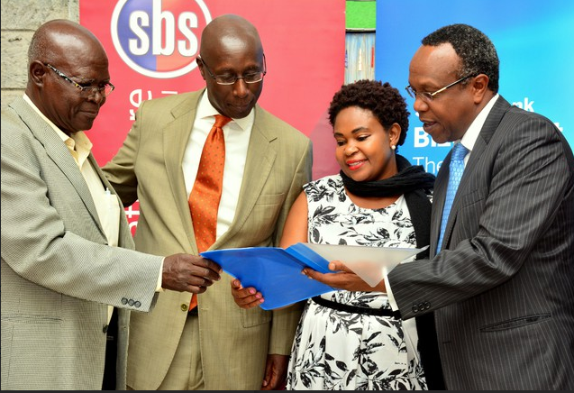 Dean of Strathmore Business School Dr. George Njenga (right) takes Stanbic Bank Chief Executive Philip Odera (second left) through an SME training programmes