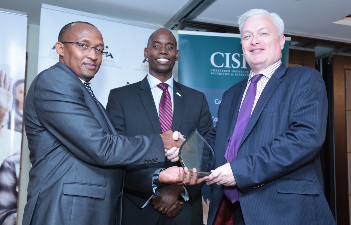 Kamunyu Njoroge, Investor Education Manager, CMA (left) receives a trophy from Kevin Moore, Director, Global Business Development, CISI . Looking on is CMA Chief Executive, Paul Muthaura (centre). Kamunyu was recognised for emerging a top ​student in the Chartered Institute for Securities and Investment (CISI) examinations for 2017
