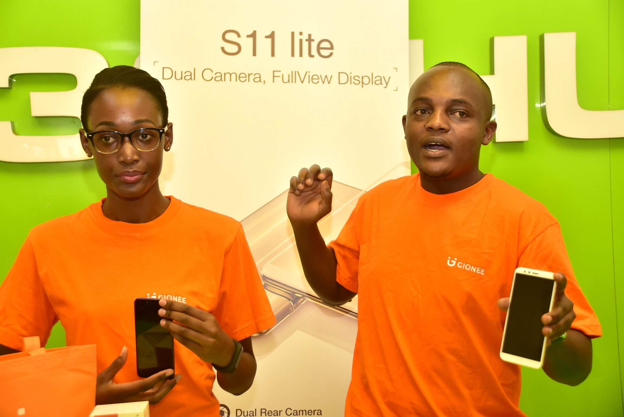 Gionee Kenya training manager Clinton Kasuti right speaks during the launch of the Gionee S11 Lite smartphone as Whitney Azande from Gionee kenya office looks on scaled