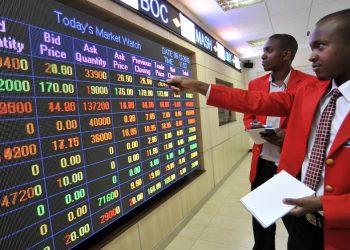 A trader points to stock information displayed on an electronic screen inside the Nairobi Securities Exchange Ltd. (NSE), Photographer: Riccardo Gangale/Bloomberg
