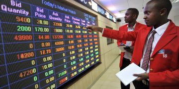 A trader points to stock information displayed on an electronic screen inside the Nairobi Securities Exchange Ltd. (NSE), Photographer: Riccardo Gangale/Bloomberg