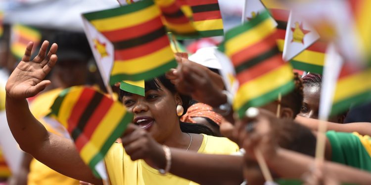 People waving Zimbabwe flags