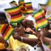 People waving Zimbabwe flags