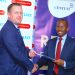 Barclays Director of Retail and Business Banking David Hardisty and Centum Real Estate Managing Director Samuel Kariuki exchange documents during the sign...