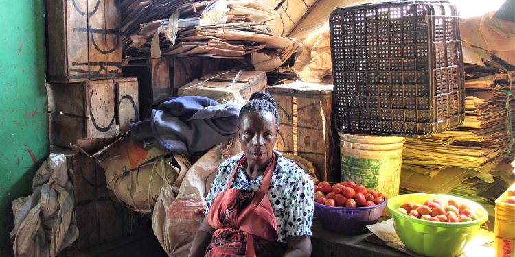 A lady selling tomatoes in an informal market. Image courtesy of Isabelle Purnell