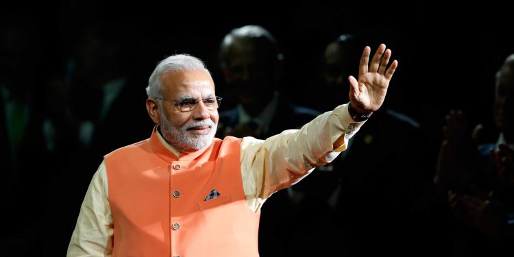 Prime Minister Narendra Modi of India waves to the crowd as he arrives to give a speech during a reception by the Indian community in honor of his visit to the United States at Madison Square Garden, Sunday, Sept. 28, 2014, in New York. (AP Photo/Jason DeCrow)