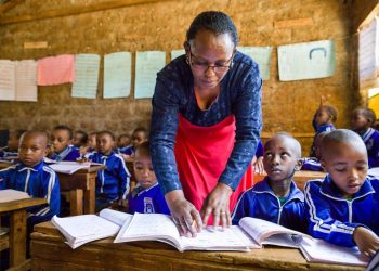 A teacher and her students in class Kenya