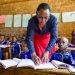 A teacher and her students in class Kenya