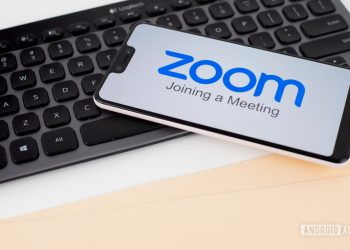 Zoom Meetings on smartphone next to office equipment stock 5