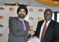 Dr. James Mwangi, Equity Bank CEO, and Ajay Banga, former MasterCard Worldwide President and CEO, celebrate an agreement between MasterCard and Equity Bank to issue five-million MasterCard® PayPassT debit, and prepaid cards at a signing ceremony in Nairobi, Kenya on Tuesday Jan. 15, 2013