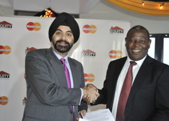 Dr. James Mwangi, Equity Bank CEO, and Ajay Banga, former MasterCard Worldwide President and CEO, celebrate an agreement between MasterCard and Equity Bank to issue five-million MasterCard® PayPassT debit, and prepaid cards at a signing ceremony in Nairobi, Kenya on Tuesday Jan. 15, 2013