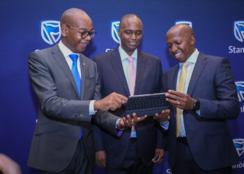 From left, Joshua Oigara, Chief executive Kenya south Sudan and Regional Chief Executive, Patrick Mweheire Chief financial value officer, Dennis Musau go through the presentation moments after the Stanbic holdings PLC full year 2022 financial results at in Nairobi.