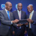From left, Joshua Oigara, Chief executive Kenya south Sudan and Regional Chief Executive, Patrick Mweheire Chief financial value officer, Dennis Musau go through the presentation moments after the Stanbic holdings PLC full year 2022 financial results at in Nairobi.