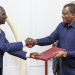 President William Ruto (L) exchanging a document with Attorney General Justin Muturi