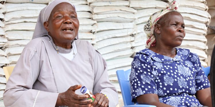 Two elderly OAF customers outside a Tupande duka