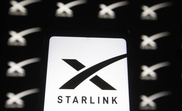 UKRAINE - 2021/02/21: In this photo illustration a Starlink logo of a satellite internet constellation being constructed by SpaceX  is seen on a smartphone and a pc screen,. (Photo Illustration by Pavlo Gonchar/SOPA Images/LightRocket via Getty Images)